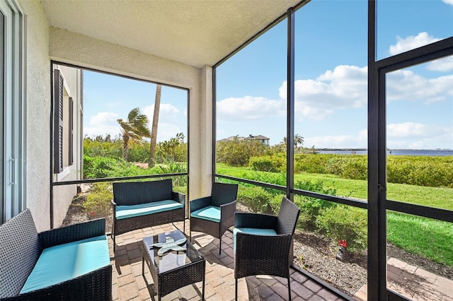 850 Tidewater Shores Loop Unit 102, Bradenton, FL 34208 - sunroom featuring a water view and outdoor lounge area