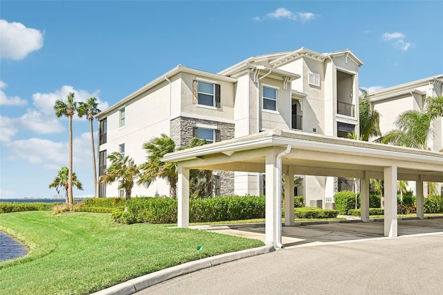 850 Tidewater Shores Loop Unit 102, Bradenton, FL 34208 - view of property featuring covered parking