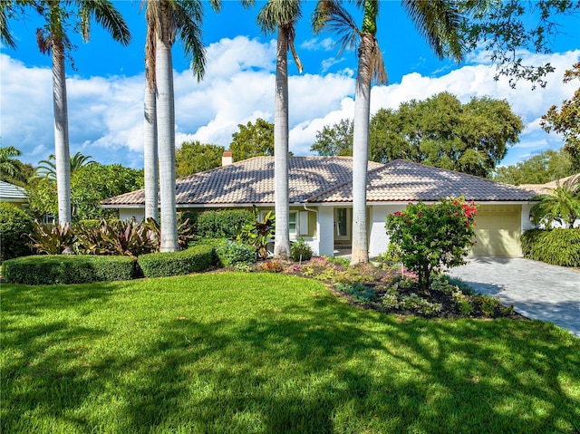 4852 Peregrine Point Cir N, Sarasota, FL 34231 - view of front facade featuring a tile roof, a garage, a front yard, driveway, and a chimney