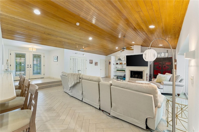 4852 Peregrine Point Cir N, Sarasota, FL 34231 - living room featuring wooden ceiling, a fireplace, french doors, vaulted ceiling, and ceiling fan