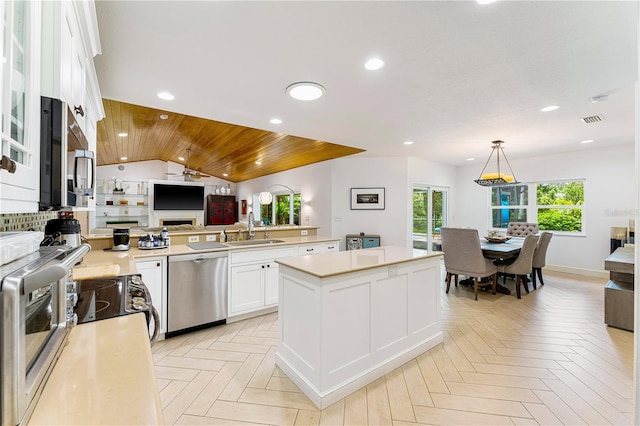 4852 Peregrine Point Cir N, Sarasota, FL 34231 - kitchen with stainless steel dishwasher, open floor plan, white cabinetry, wood ceiling, and recessed lighting
