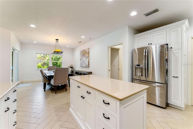 4852 Peregrine Point Cir N, Sarasota, FL 34231 - kitchen featuring stainless steel fridge, light countertops, a center island, white cabinets, and recessed lighting