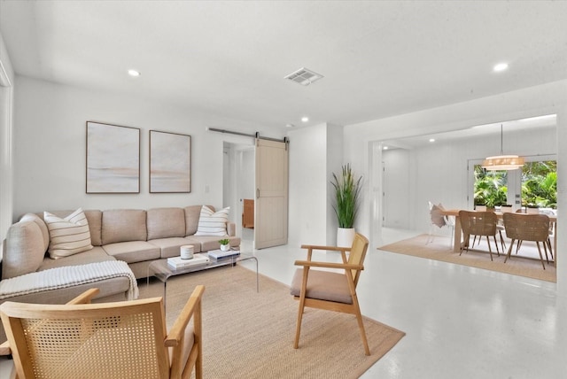 1051 Indian Beach Dr, Sarasota, FL 34234 - living room featuring recessed lighting, a barn door, and concrete flooring