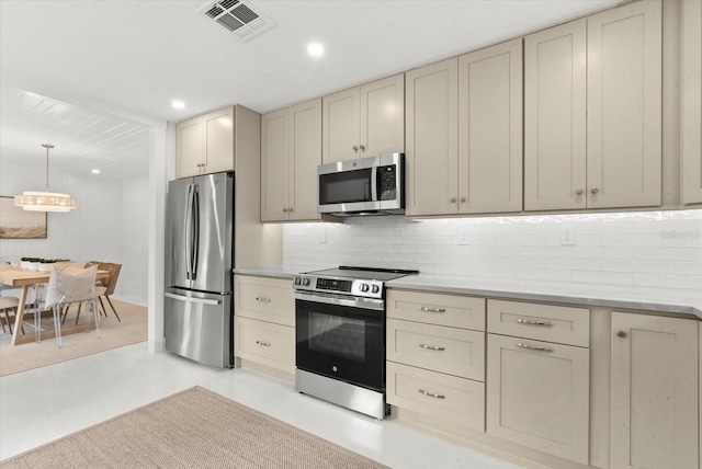 1051 Indian Beach Dr, Sarasota, FL 34234 - kitchen featuring stainless steel appliances, cream cabinets, tasteful backsplash, light countertops, and recessed lighting