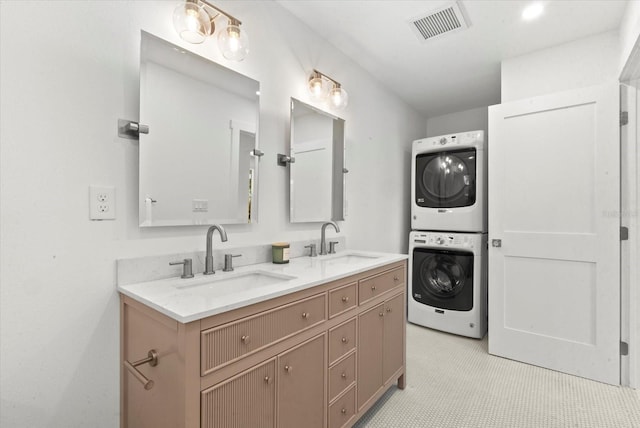 1051 Indian Beach Dr, Sarasota, FL 34234 - bathroom featuring stacked washing machine and dryer and double vanity
