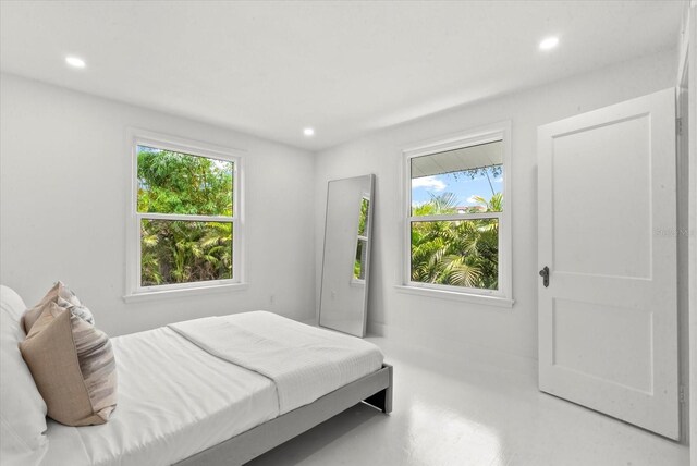 1051 Indian Beach Dr, Sarasota, FL 34234 - bedroom with multiple windows and recessed lighting