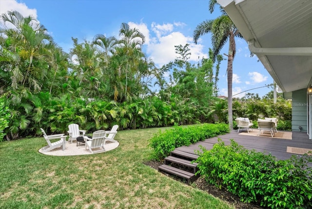 1051 Indian Beach Dr, Sarasota, FL 34234 - view of grassy yard featuring a fire pit and a wooden deck