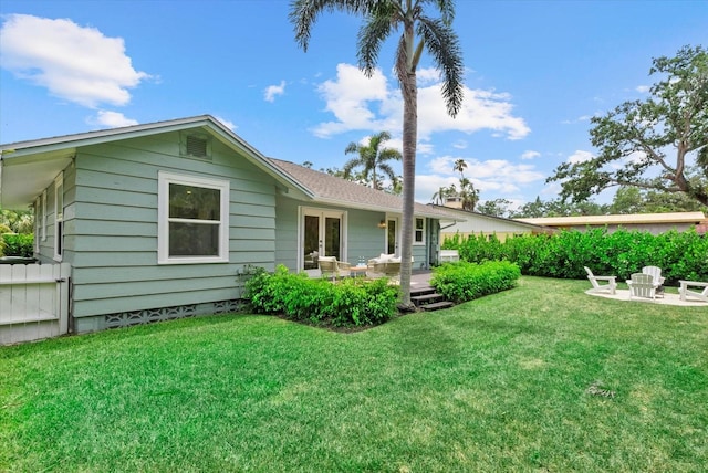1051 Indian Beach Dr, Sarasota, FL 34234 - rear view of house with french doors, a yard, a deck, and a patio