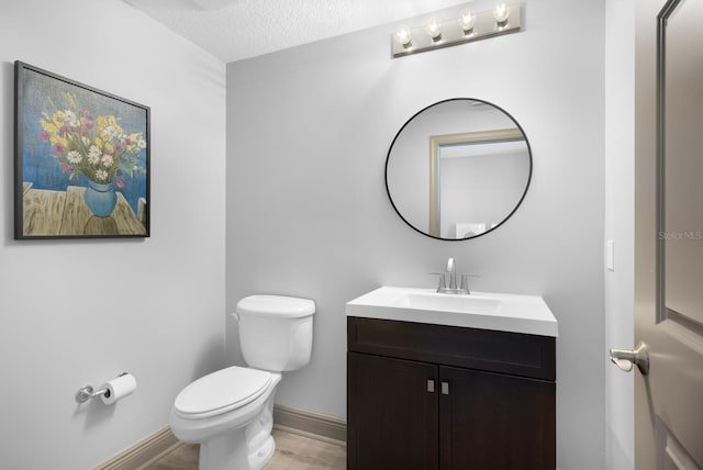 800 N Tamiami Trl Unit 405, Sarasota, FL 34236 - half bath with vanity, wood finished floors, and a textured ceiling
