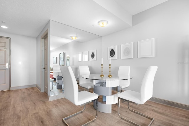 800 N Tamiami Trl Unit 405, Sarasota, FL 34236 - dining area featuring wood finished floors and baseboards