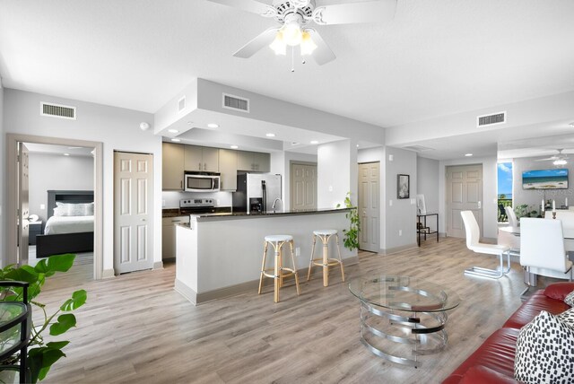 800 N Tamiami Trl Unit 405, Sarasota, FL 34236 - living area featuring a ceiling fan, light wood-type flooring, and recessed lighting