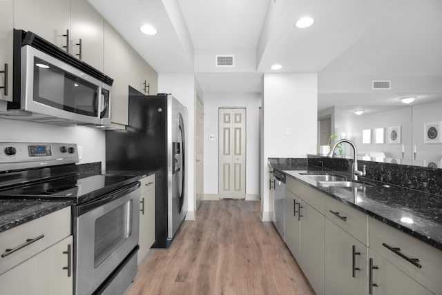 800 N Tamiami Trl Unit 405, Sarasota, FL 34236 - kitchen with appliances with stainless steel finishes, light wood-style floors, dark stone countertops, and recessed lighting