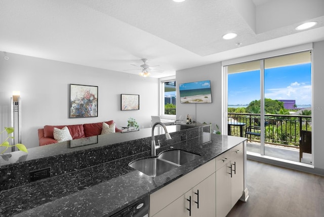 800 N Tamiami Trl Unit 405, Sarasota, FL 34236 - kitchen with dark wood-type flooring, white cabinets, dark stone countertops, recessed lighting, and open floor plan