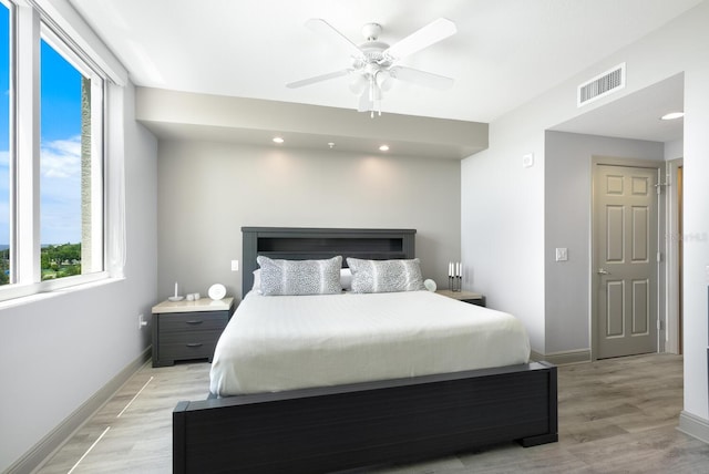800 N Tamiami Trl Unit 405, Sarasota, FL 34236 - bedroom featuring multiple windows, light wood finished floors, recessed lighting, and ceiling fan