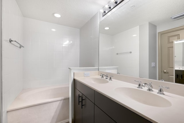 800 N Tamiami Trl Unit 405, Sarasota, FL 34236 - full bathroom with double vanity, a textured ceiling, and recessed lighting