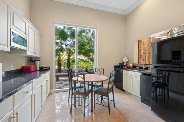 800 N Tamiami Trl Unit 405, Sarasota, FL 34236 - dining room featuring ornamental molding and light tile patterned floors