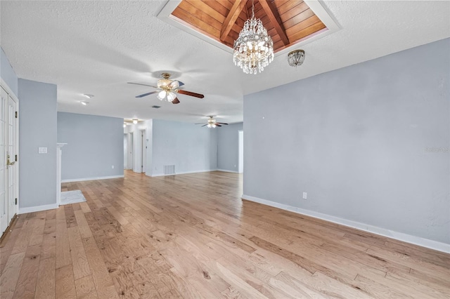 6103 6th Ave NW, Bradenton, FL 34209 - unfurnished living room featuring ceiling fan, light wood finished floors, a chandelier, and a textured ceiling
