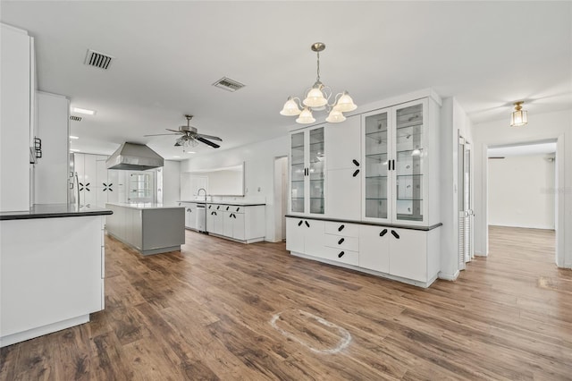 6103 6th Ave NW, Bradenton, FL 34209 - kitchen with wood finished floors, dishwasher, a kitchen island, white cabinetry, and glass insert cabinets