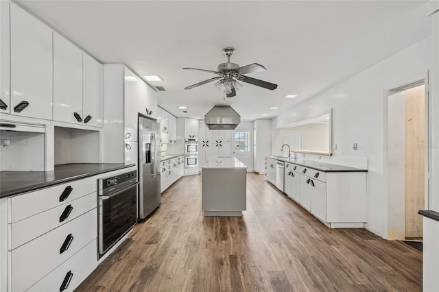 6103 6th Ave NW, Bradenton, FL 34209 - kitchen featuring a ceiling fan, stainless steel fridge, dark wood finished floors, and white cabinetry