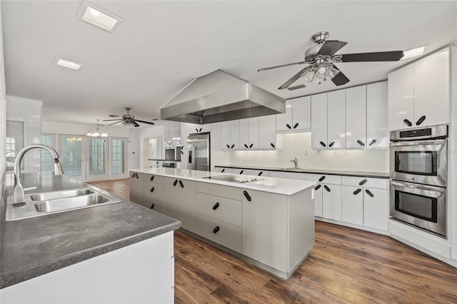 6103 6th Ave NW, Bradenton, FL 34209 - kitchen featuring stainless steel appliances, ceiling fan, wall chimney exhaust hood, and a center island