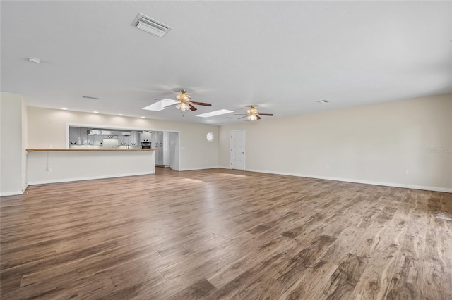 6103 6th Ave NW, Bradenton, FL 34209 - unfurnished living room with wood finished floors and ceiling fan