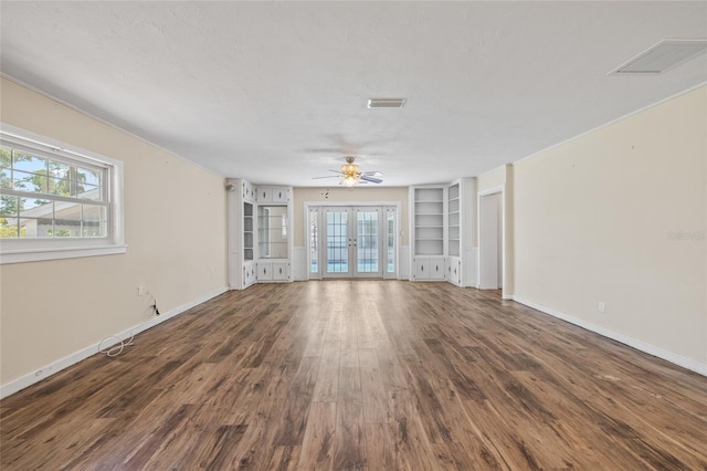 6103 6th Ave NW, Bradenton, FL 34209 - unfurnished living room with french doors, wood finished floors, built in shelves, and ceiling fan