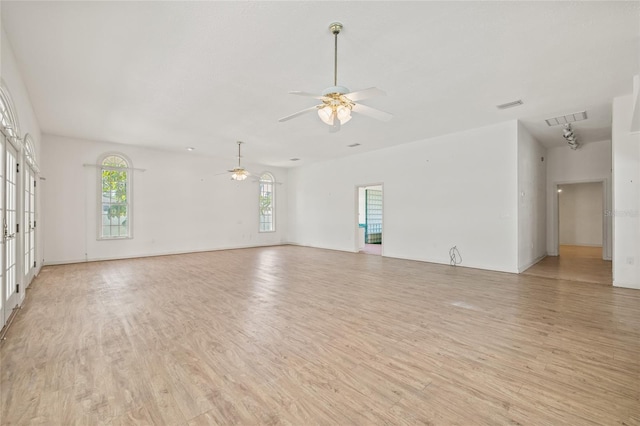 6103 6th Ave NW, Bradenton, FL 34209 - unfurnished living room with a ceiling fan, light wood-style floors, and french doors