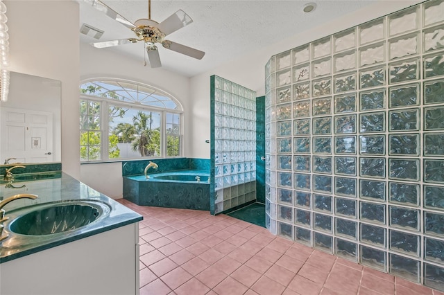 6103 6th Ave NW, Bradenton, FL 34209 - bathroom with tile patterned flooring, a bath, ceiling fan, double vanity, and a textured ceiling