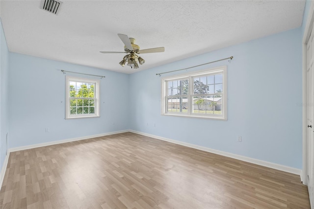 6103 6th Ave NW, Bradenton, FL 34209 - spare room with wood finished floors, a ceiling fan, and a textured ceiling
