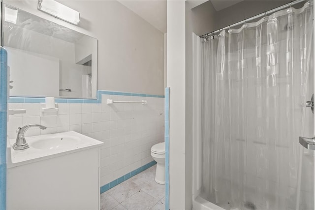 6103 6th Ave NW, Bradenton, FL 34209 - bathroom with vanity, tile walls, wainscoting, tile patterned flooring, and shower / bath combo with shower curtain