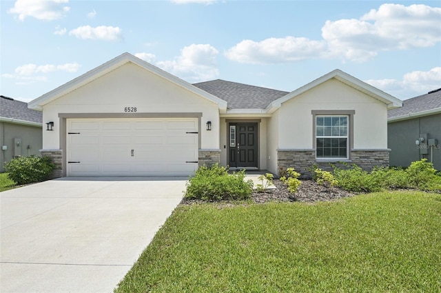 6528 166th Pl E, Parrish, FL 34219 - ranch-style house featuring stone siding, a front lawn, driveway, a garage, and stucco siding
