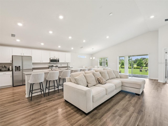 6528 166th Pl E, Parrish, FL 34219 - living area with recessed lighting, wood finished floors, and vaulted ceiling