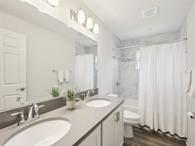 6528 166th Pl E, Parrish, FL 34219 - bathroom with double vanity, wood finished floors, and shower / bath combo