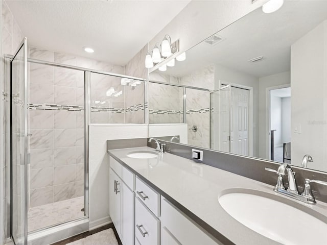 6528 166th Pl E, Parrish, FL 34219 - bathroom with a stall shower, double vanity, and recessed lighting