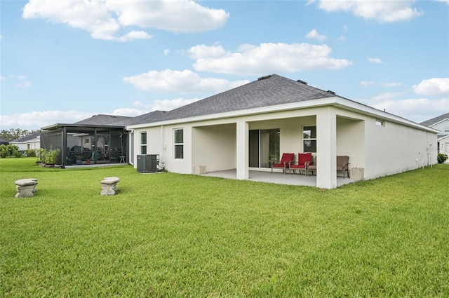 6528 166th Pl E, Parrish, FL 34219 - rear view of house featuring a patio, stucco siding, a lawn, a shingled roof, and a sunroom