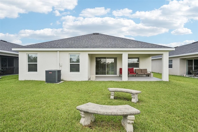 6528 166th Pl E, Parrish, FL 34219 - back of property featuring roof with shingles, outdoor lounge area, a patio area, stucco siding, and a lawn