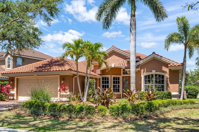7521 Aralia Way, Seminole, FL 33777 - mediterranean / spanish house with an attached garage, stucco siding, and a tile roof