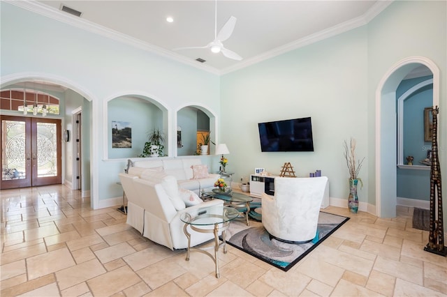7521 Aralia Way, Seminole, FL 33777 - living room with stone tile flooring, french doors, ceiling fan, crown molding, and arched walkways