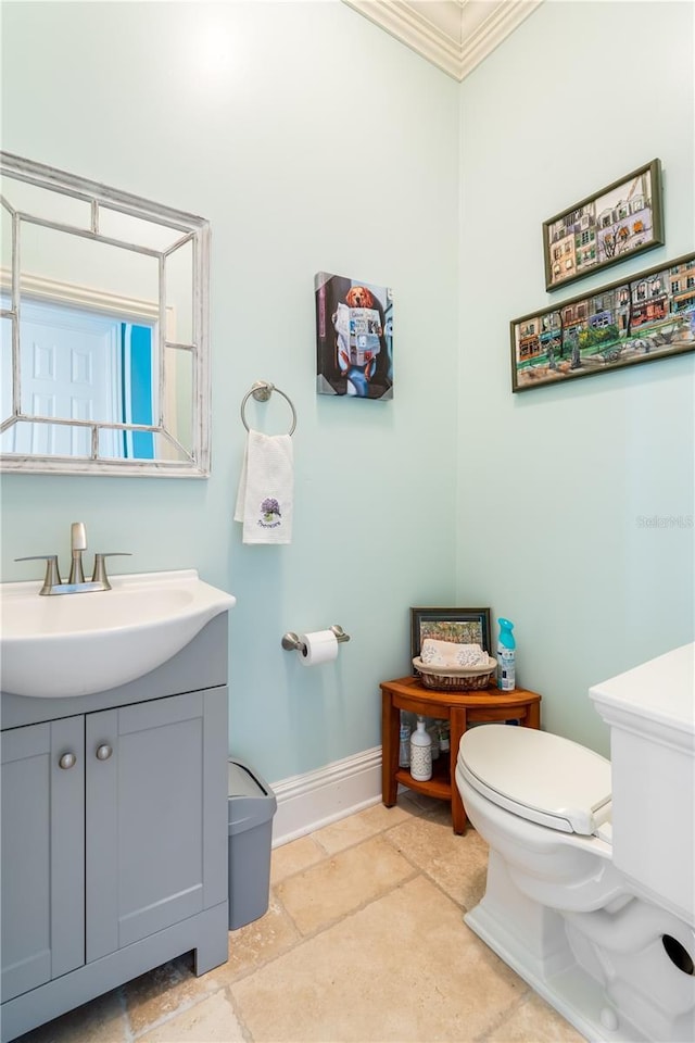 7521 Aralia Way, Seminole, FL 33777 - half bathroom featuring vanity, ornamental molding, and stone finish flooring