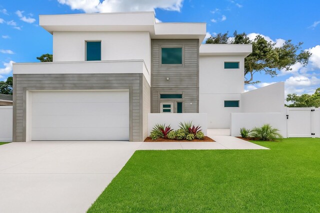 2065 Goldenrod St, Sarasota, FL 34239 - contemporary home with stucco siding, concrete driveway, a gate, and an attached garage