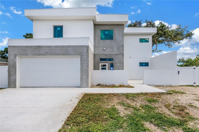 2065 Goldenrod St, Sarasota, FL 34239 - view of front facade with stucco siding, driveway, a gate, and an attached garage