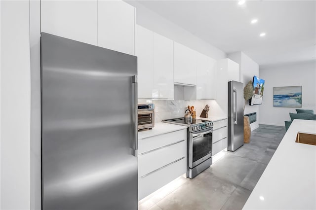 2065 Goldenrod St, Sarasota, FL 34239 - kitchen with stainless steel appliances, modern cabinets, light countertops, white cabinets, and finished concrete flooring