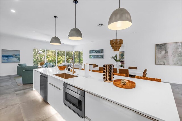 2065 Goldenrod St, Sarasota, FL 34239 - kitchen with appliances with stainless steel finishes, modern cabinets, white cabinetry, light countertops, and decorative light fixtures