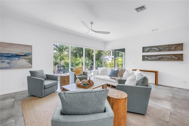 2065 Goldenrod St, Sarasota, FL 34239 - living room with healthy amount of natural light, a ceiling fan, and concrete flooring