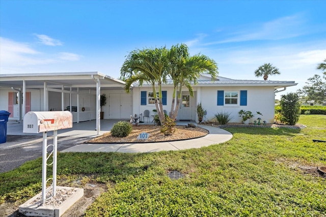 107 Clipper Way Unit 107, Nokomis, FL 34275 - ranch-style home featuring a carport, a front yard, asphalt driveway, and stucco siding