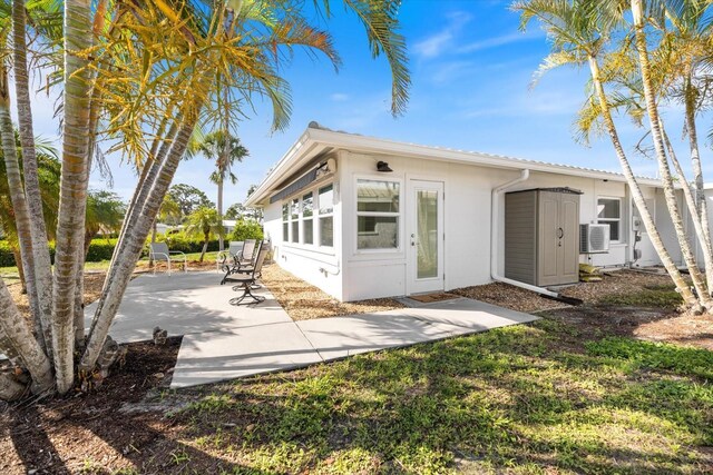 107 Clipper Way Unit 107, Nokomis, FL 34275 - rear view of house with a patio, stucco siding, and an outdoor structure