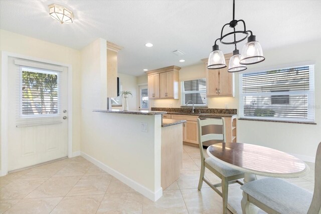 107 Clipper Way Unit 107, Nokomis, FL 34275 - kitchen with light brown cabinetry, light tile patterned flooring, a chandelier, stainless steel dishwasher, and a peninsula