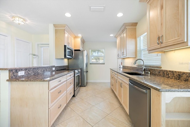 107 Clipper Way Unit 107, Nokomis, FL 34275 - kitchen with appliances with stainless steel finishes, light brown cabinetry, a peninsula, and recessed lighting