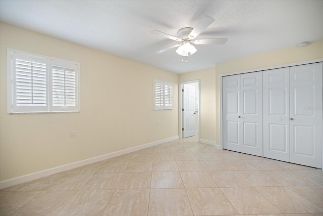 107 Clipper Way Unit 107, Nokomis, FL 34275 - unfurnished bedroom featuring a closet, a ceiling fan, and a textured ceiling