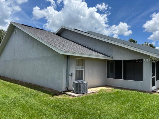 888 W Stuart St, Bartow, FL 33830 - back of house with a lawn, roof with shingles, and stucco siding